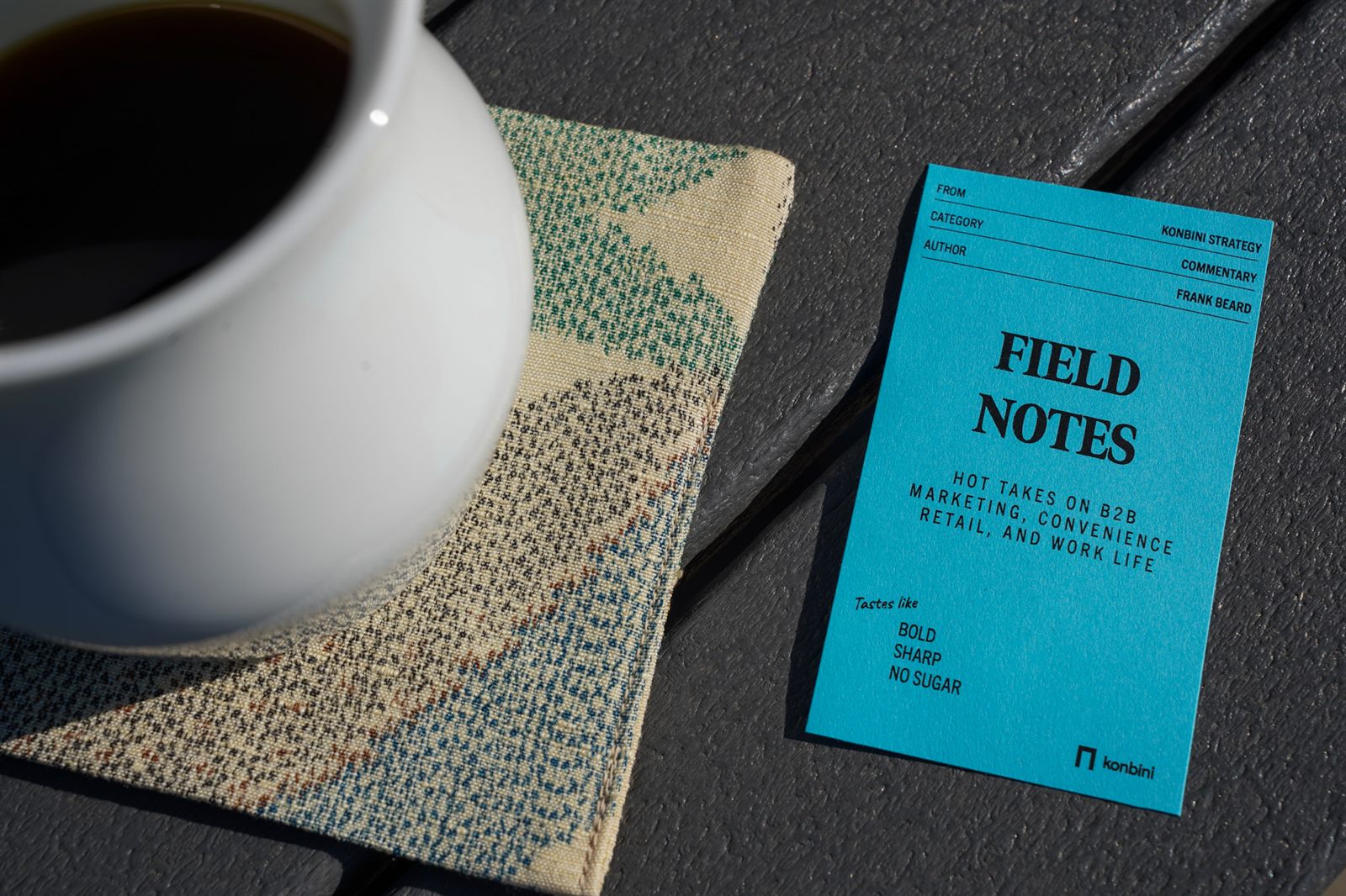 A Field Notes card beside a cup of coffee