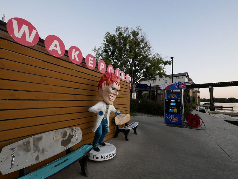 A lakeside fuel and retail stop at dusk